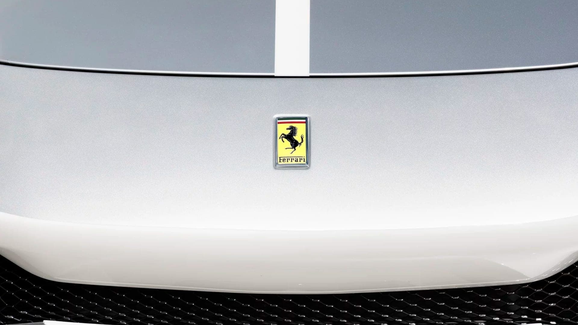 Ferrari prancing horse badge on the white nose of a 296 GTB