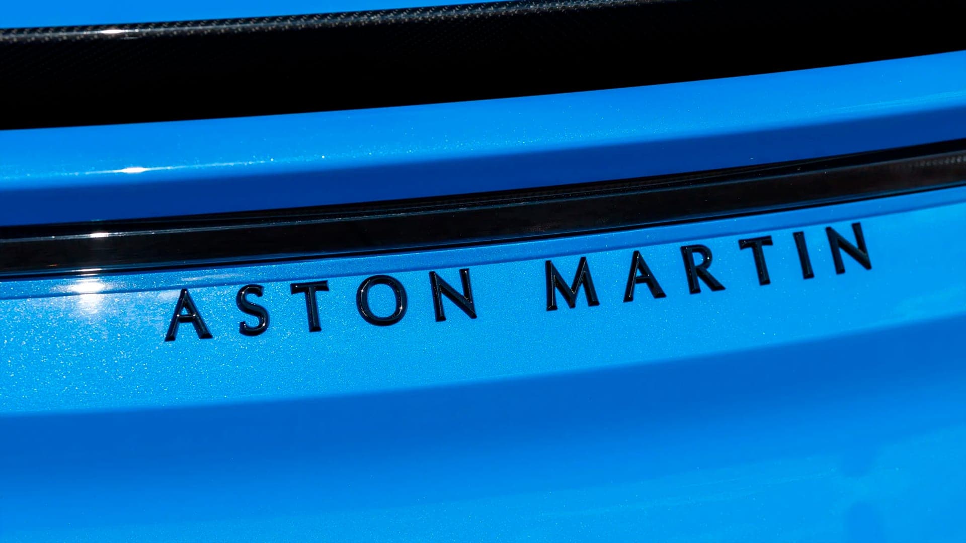 Aston Martin lettering on blue paintwork